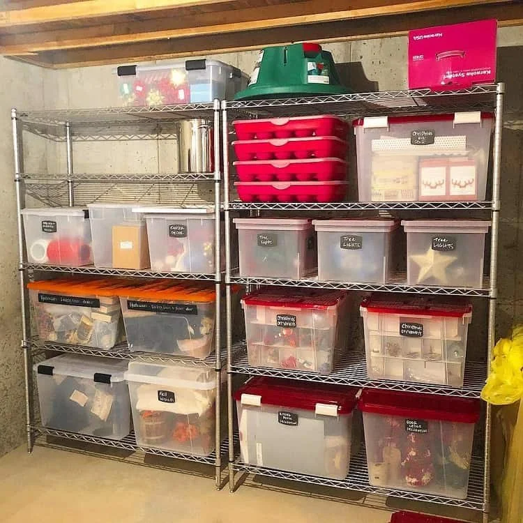 Metal wire shelving in a basement holding labeled plastic bins elevated off the concrete floor.