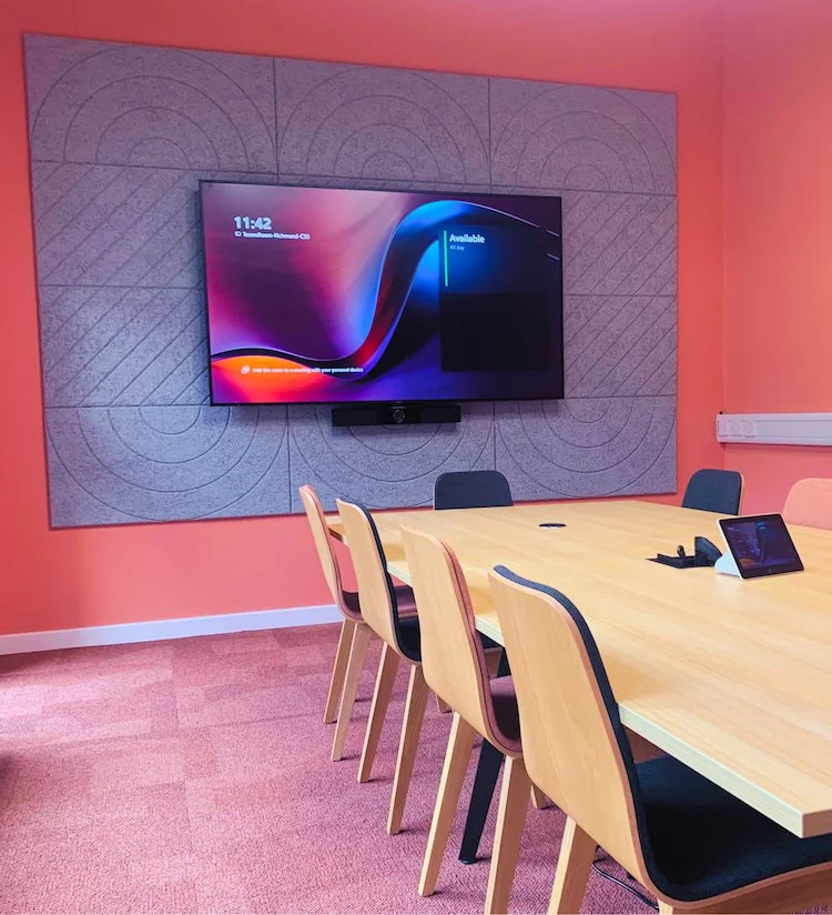 Microsoft Teams Room with wall-mounted display, video conferencing camera and touchscreen meeting controller