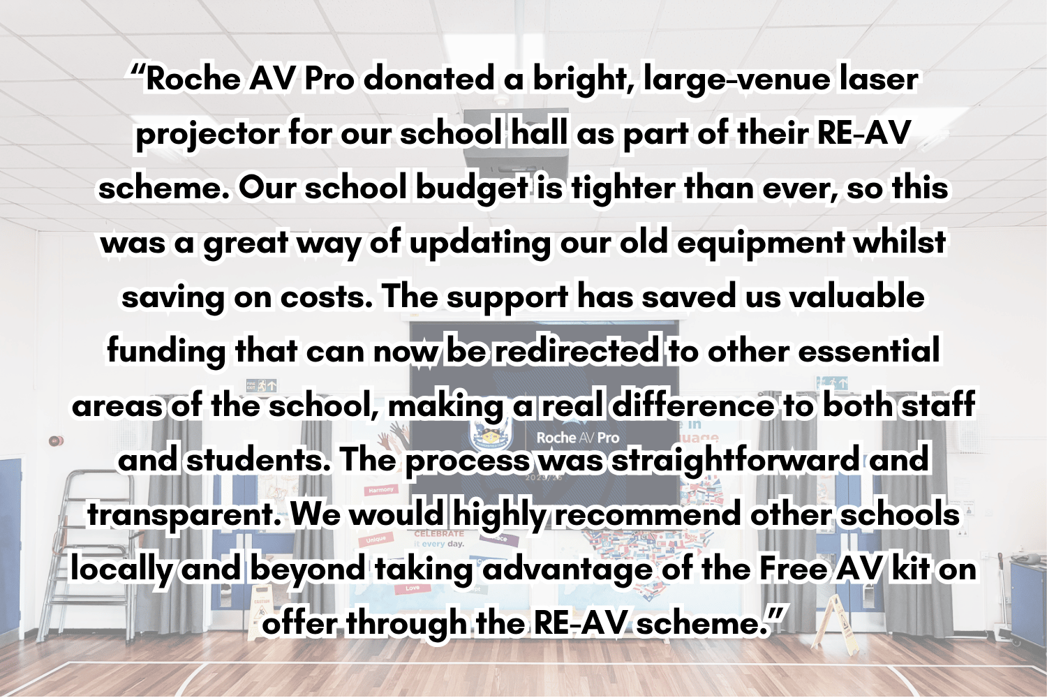 Text overlay on a school hall background, describing a donation of a laser projector by Roche AV Pro for the school, highlighting the benefits of the support and recommendation for other schools to use the scheme.
