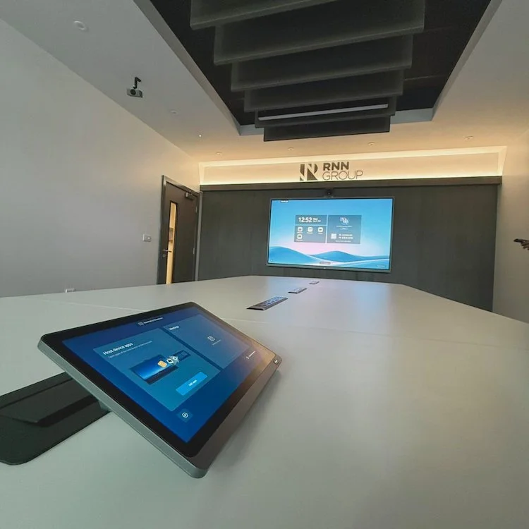 Microsoft Teams meeting room at RNN Group with integrated display and touchscreen room controller