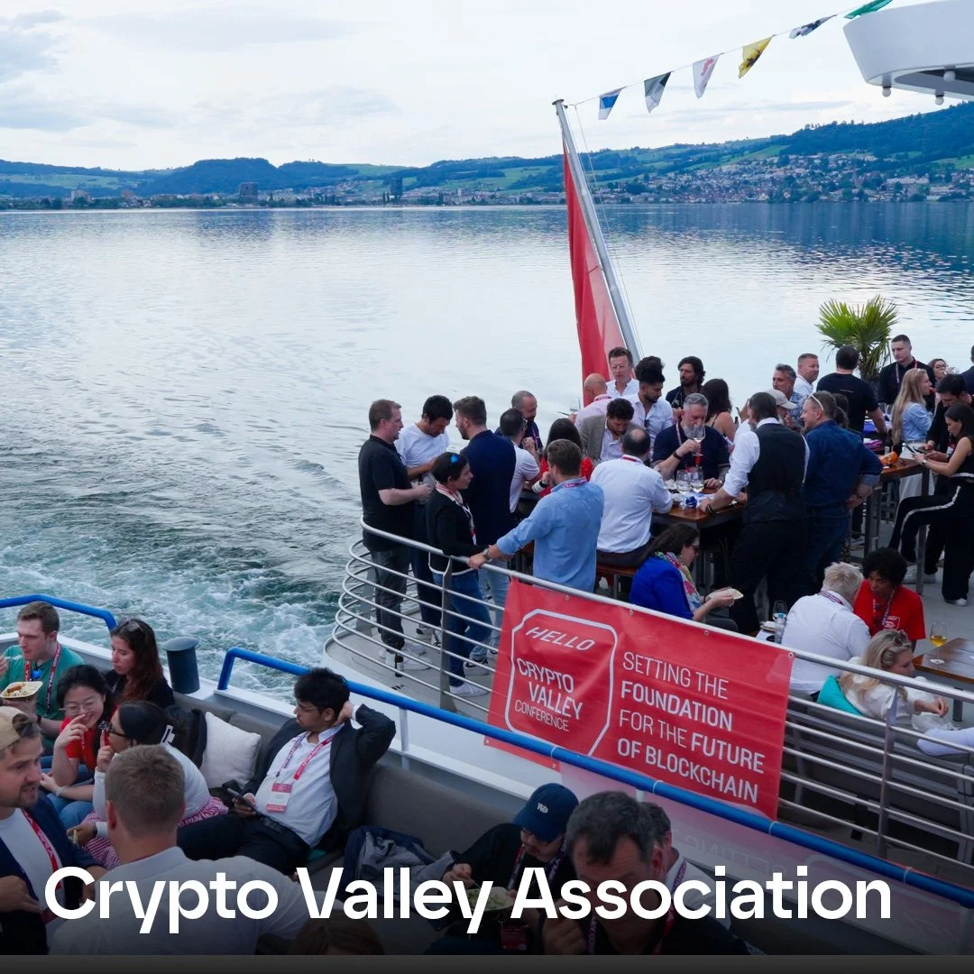 People gathered on a boat for the Crypto Valley Conference, with a banner reading 'Setting the foundation for the future of blockchain' and a scenic lake and hills in the background.