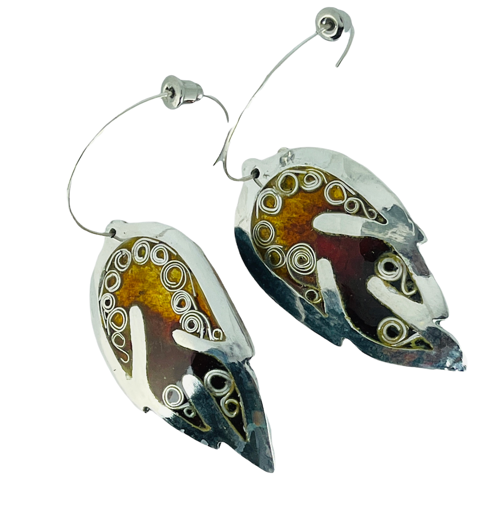 Silver and amber-colored earrings with circular and spiral designs.