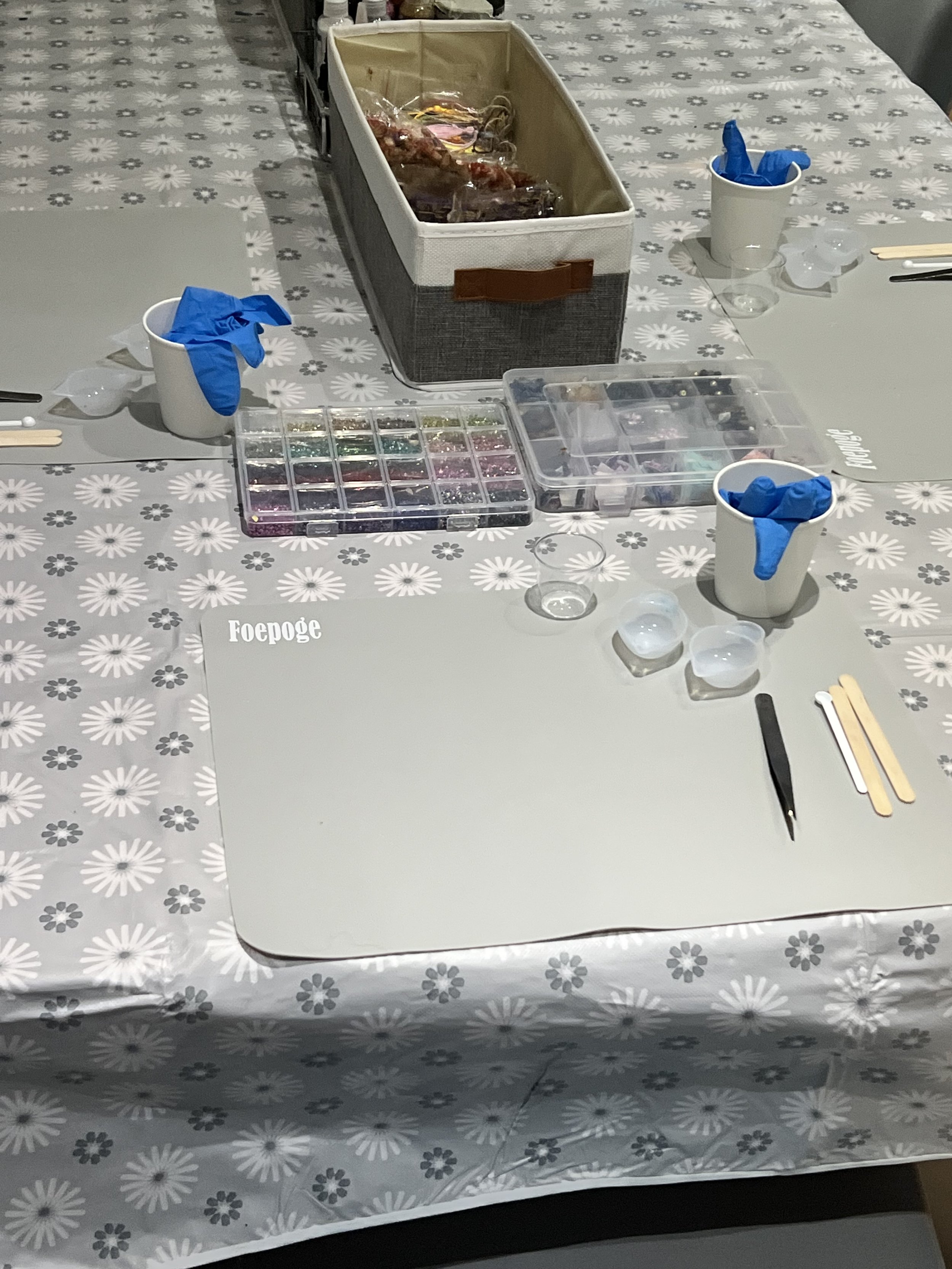 Table set up for a nail art activity with nail polish, glitters, and tools.