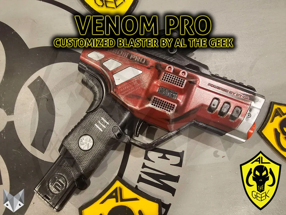 A custom red and black Nerf gun called Venom Pro with a modified design, displayed on a surface with comic style graphics and yellow shield logos from the Al The Geek collection.
