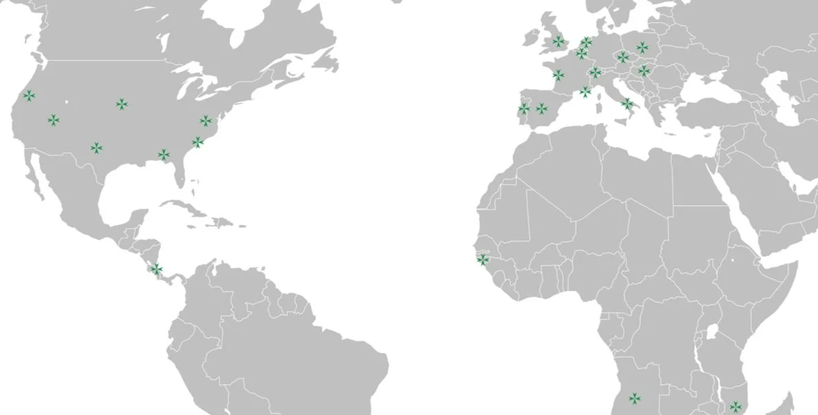 World map with green star icons indicating multiple locations including the United States, Canada, Europe, South America, and Africa.