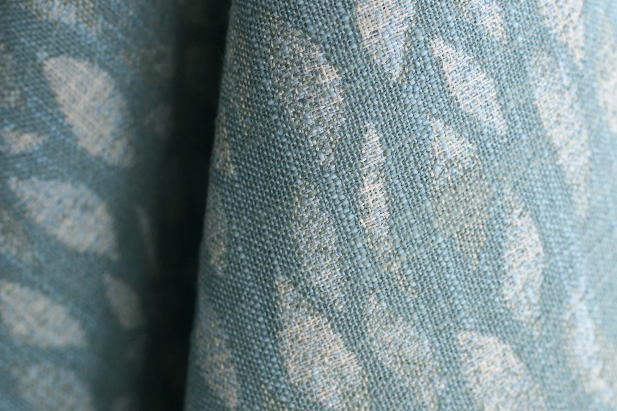 Petals Woven fabric in Blue by Rebecca Atwood, draped to show the woven leaf pattern