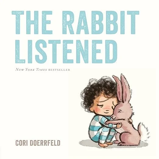 Cover of a children's book titled 'The Rabbit Listened' by Cori Doerrfeld, featuring an illustration of a young child with curly hair and a striped shirt hugging and comforting a pink rabbit.