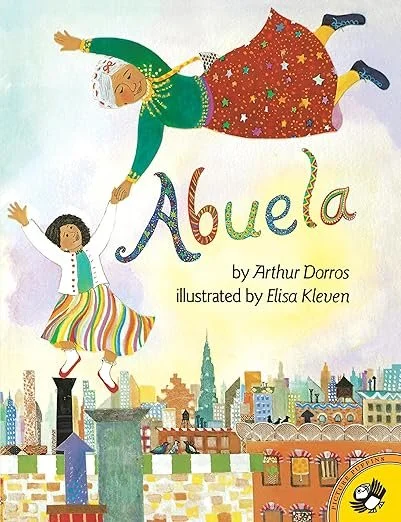 Cover of a children's book titled 'Abuela' by Arthur Dorros, illustrated by Elisa Kleven, featuring an elderly woman with gray hair in a red skirt with stars, holding hands with a young girl in a colorful striped skirt, flying over a cityscape.