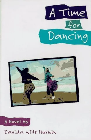 Book cover titled "A Time for Dancing" by Davida Willis Hurwin, featuring an illustration of two girls dancing on a beach with a blue sky and clouds in the background.