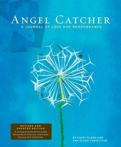 Book cover titled 'Angel Catcher: A Journal of Loss and Remembrance' by Kathy Eldon and Amy Eldon Turtletaub. The cover features a dandelion seed head with some seeds blowing away, set against a blue background.
