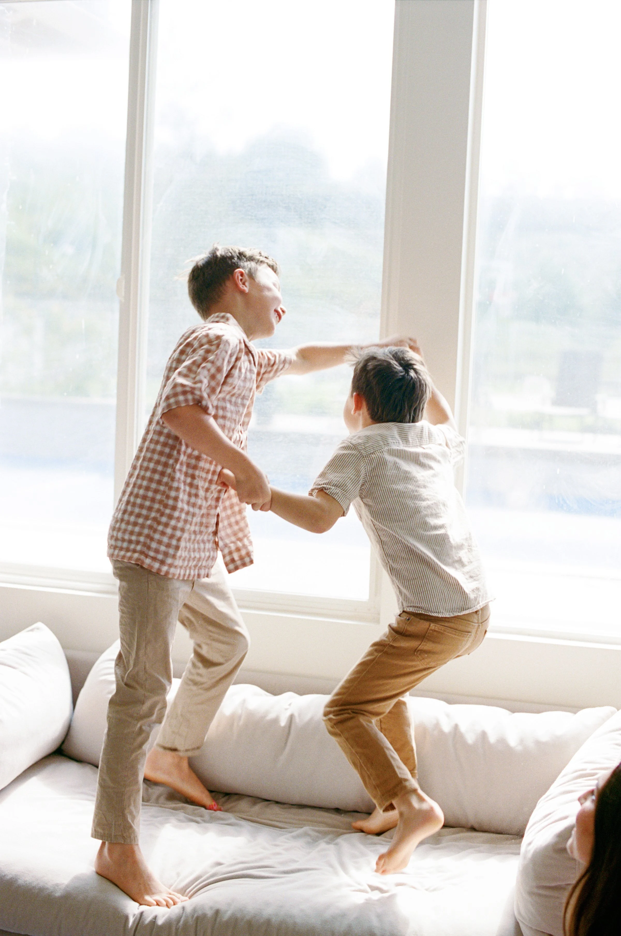 Kids playing naturally during an in-home family session in Orange County