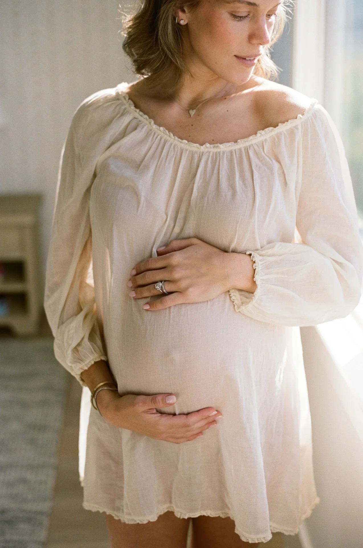 a pregnant woman holding her belly film photoshoot in San Clemente, Orange County