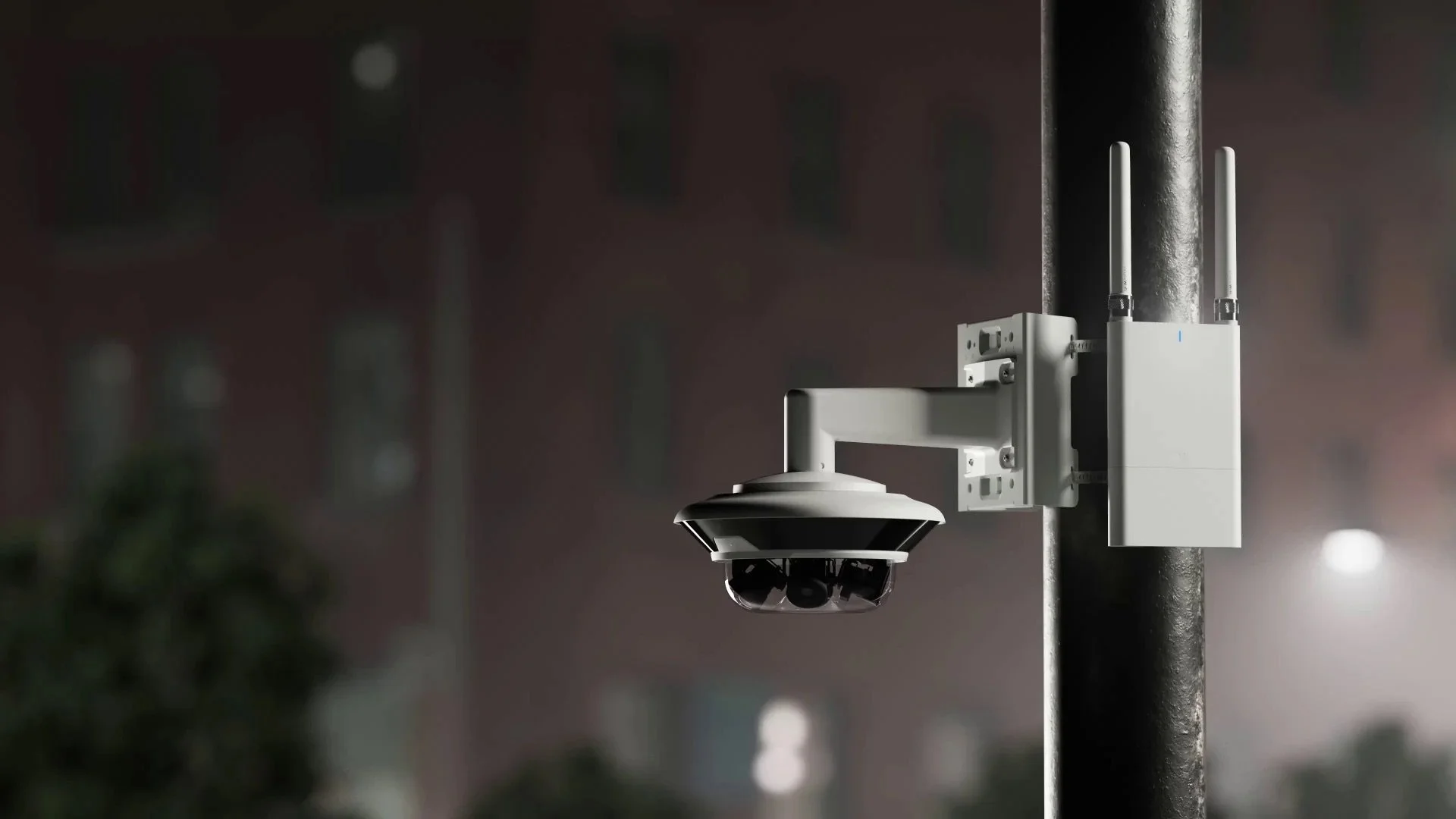 Outdoor security camera mounted on a pole with attached antenna device.
