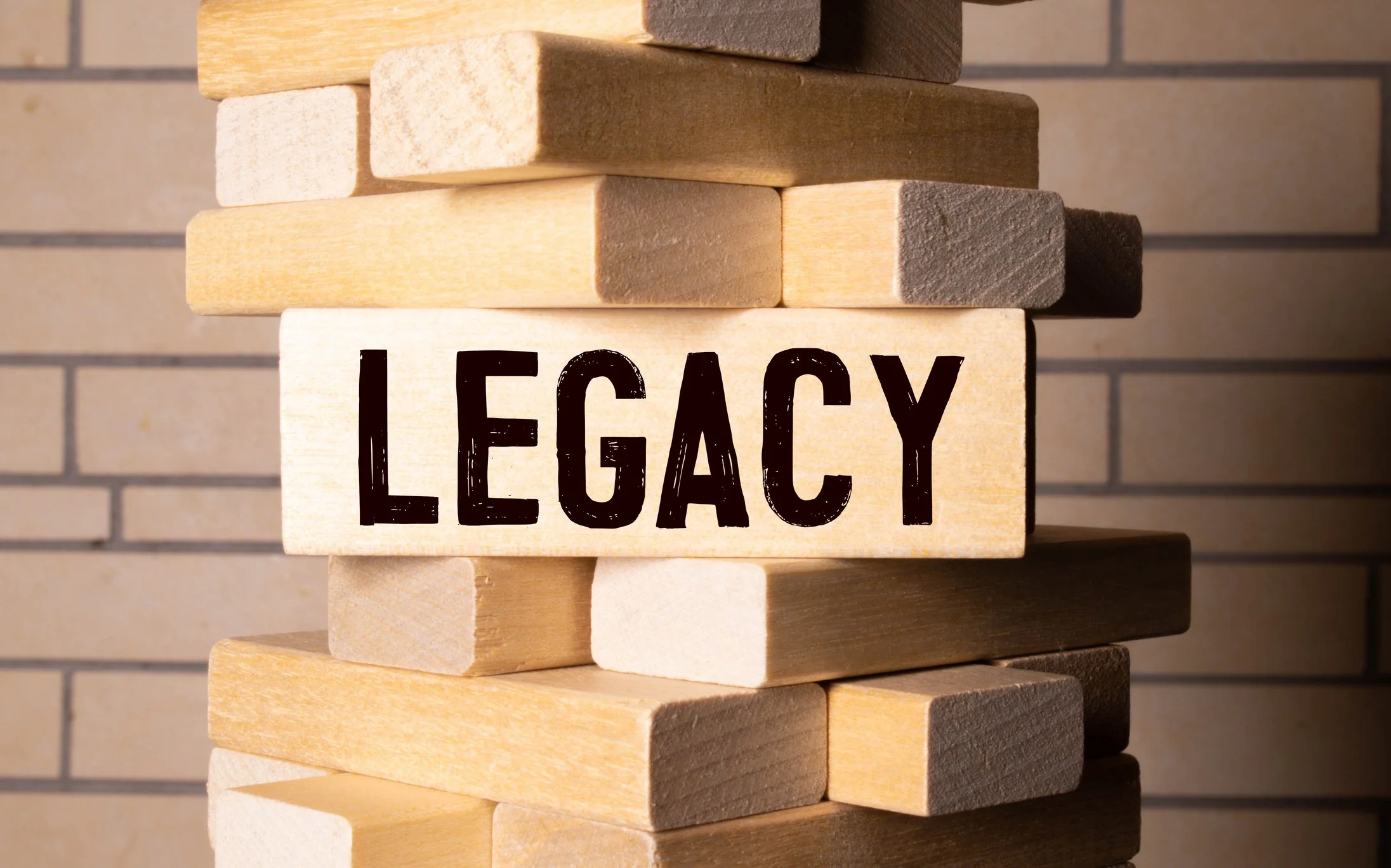 the word legacy is spelled out on a piece of wood