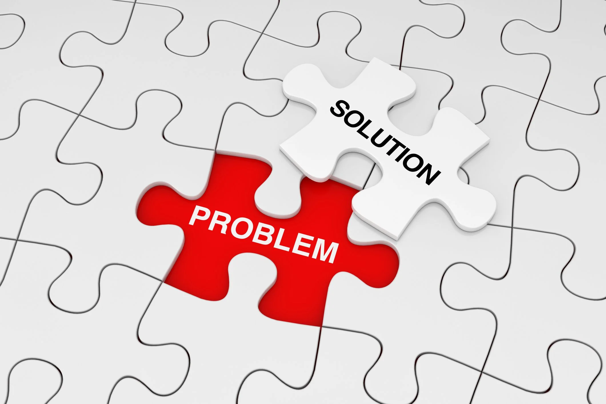 puzzles pieces with red spelling out problem and a missing one spelling out solution