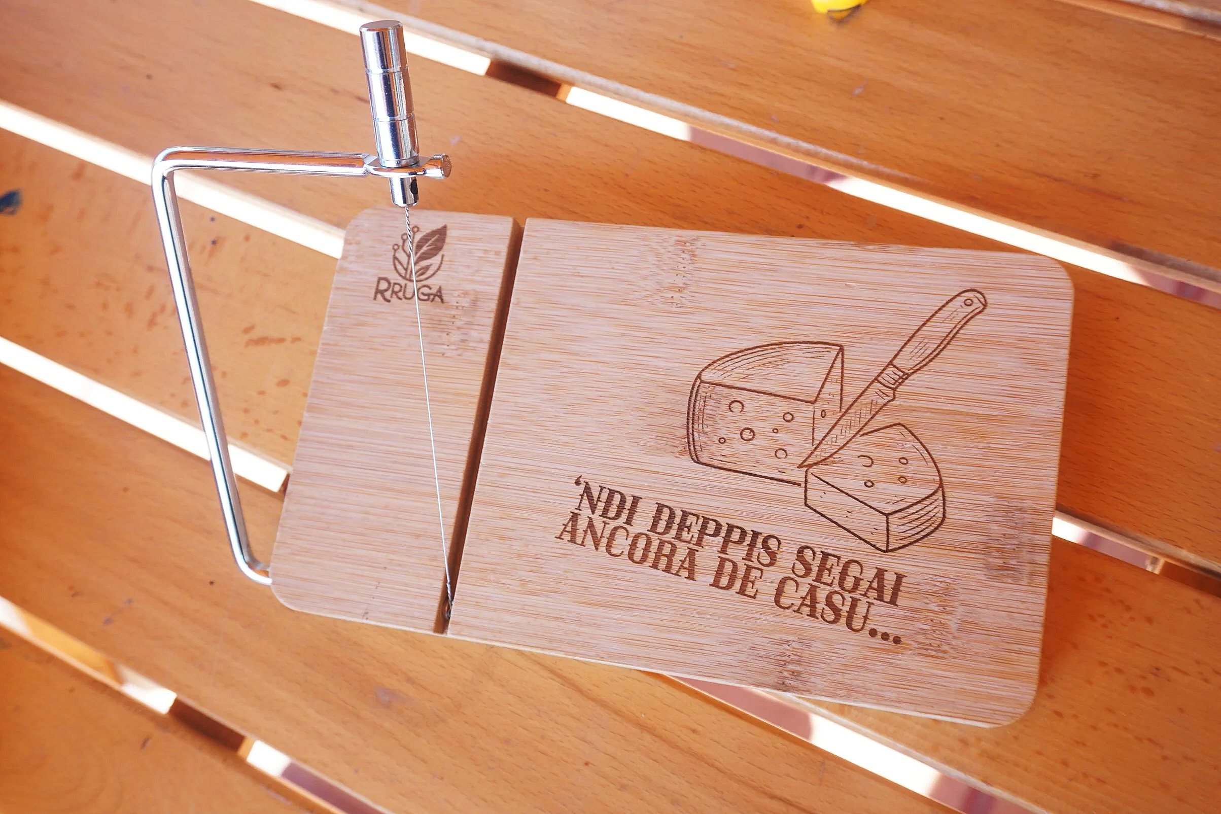 Tagliere in bambù con affettaformaggio in acciaio inox, personalizzato tramite incisione laser.

Il progetto unisce funzionalità e identità, trasformando un oggetto da cucina in un elemento narrativo.
L’incisione raffigura il taglio del formaggio acc