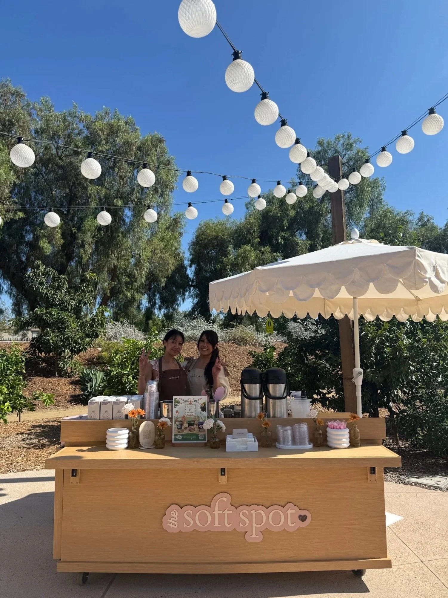 Mobile matcha and espresso bar outdoor setup with string lights by The Soft Spot at a private event