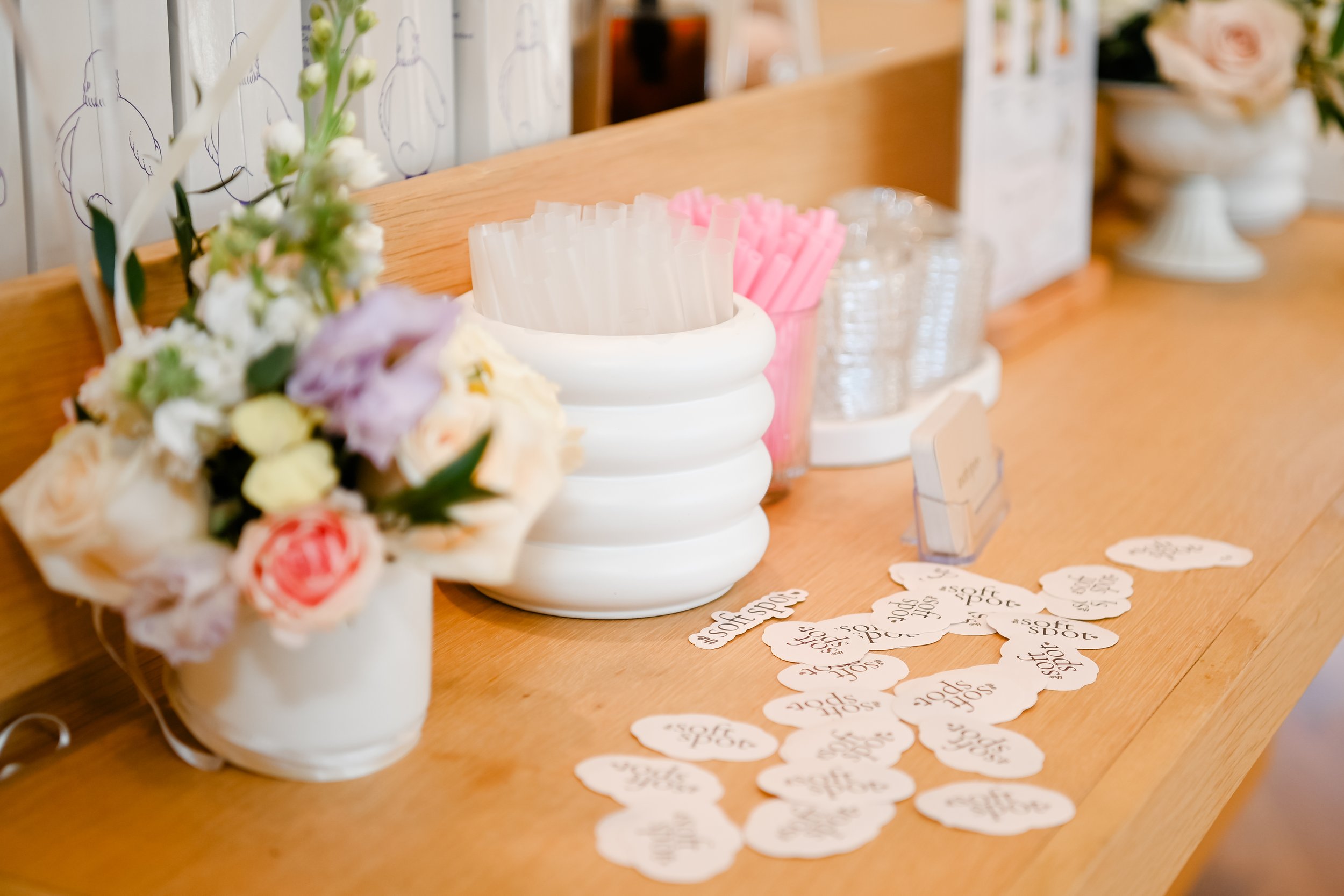 Styled details on The Soft Spot matcha bar featuring flowers and branded elements at an event