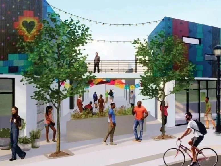 A vibrant outdoor rendering of urban scene with people walking, biking, and socializing near colorful murals on buildings. Trees line the sidewalk, and a person stands on an upper balcony, while others gather under a decorative umbrella canopy.