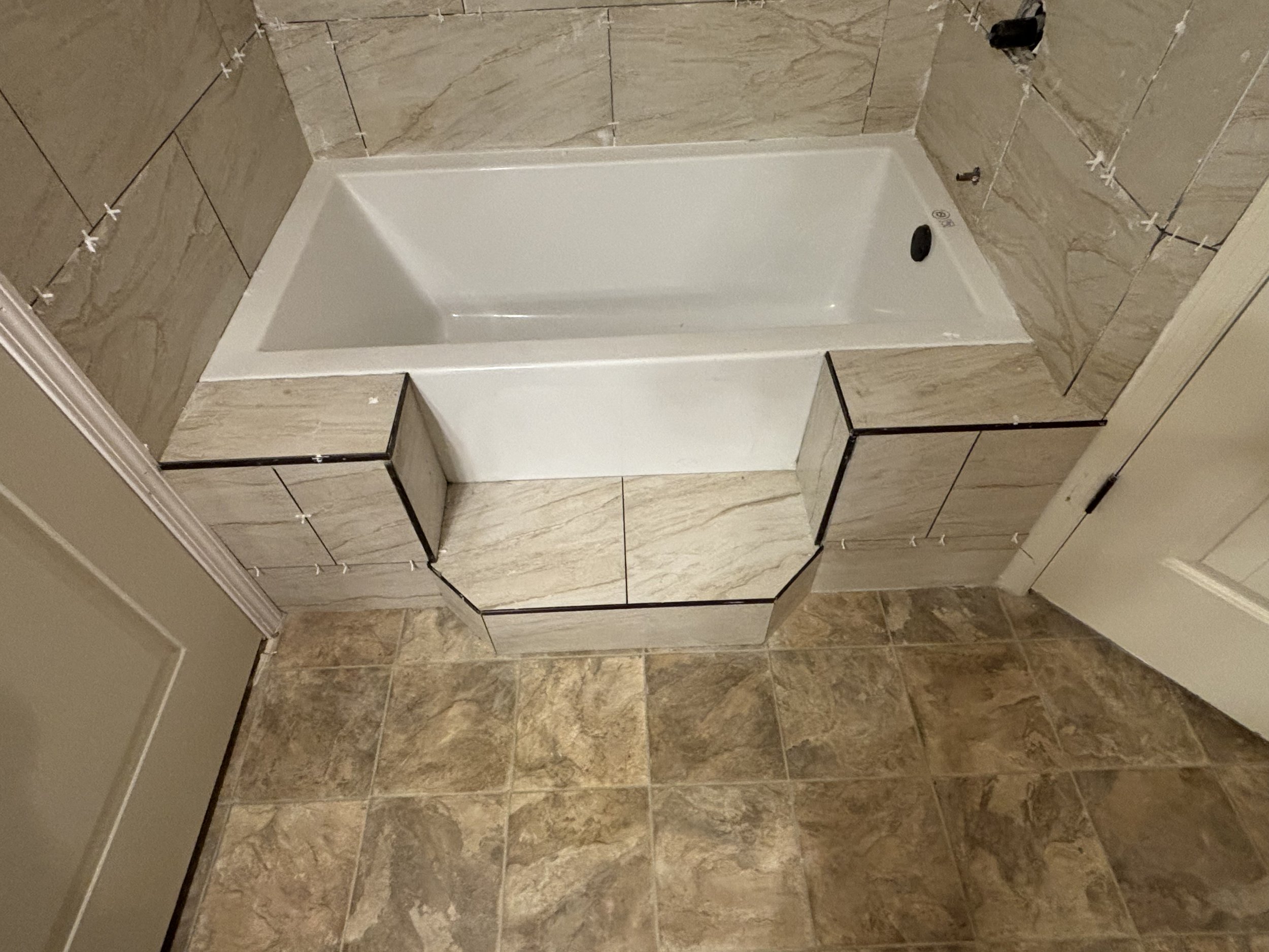 Low-entry steps leading to bathtub.