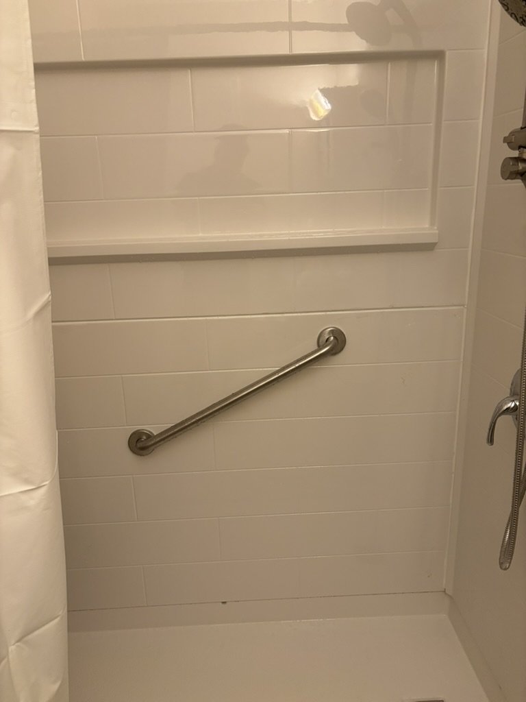 Grab bar inside a zero-entry bathroom for enhanced safety and accessibility.