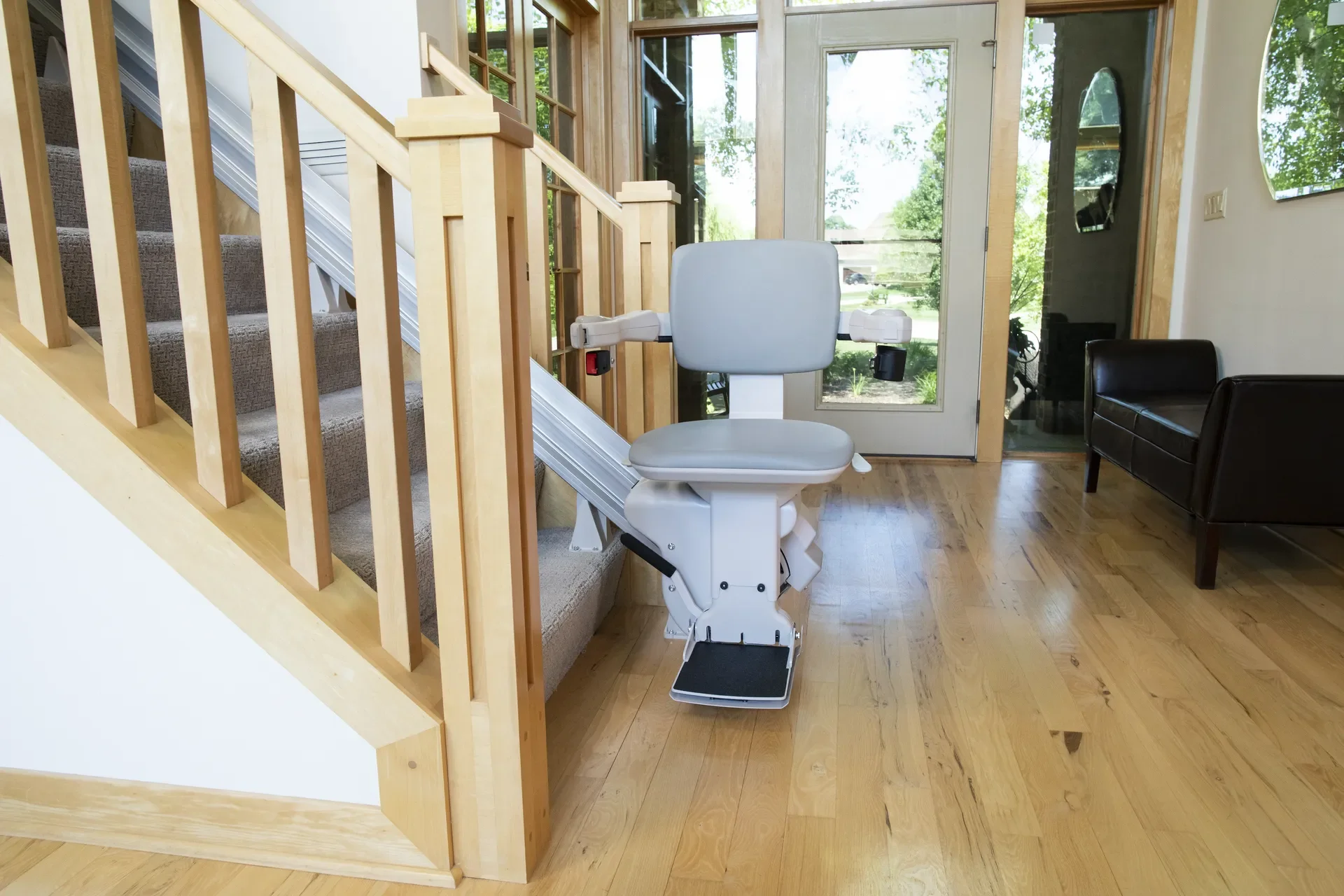 Atlas 500 stair lift professionally installed on a straight staircase, providing safe, smooth, and reliable accessibility for homeowners with mobility challenges.