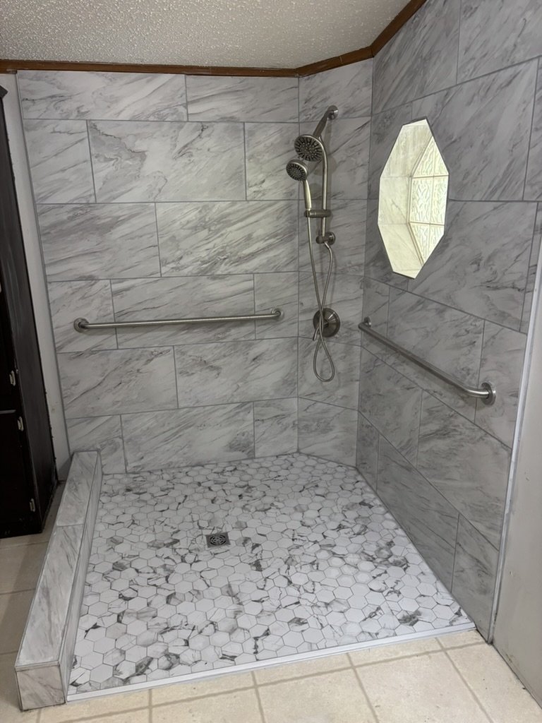 Remodeled zero entry shower with grab bars.