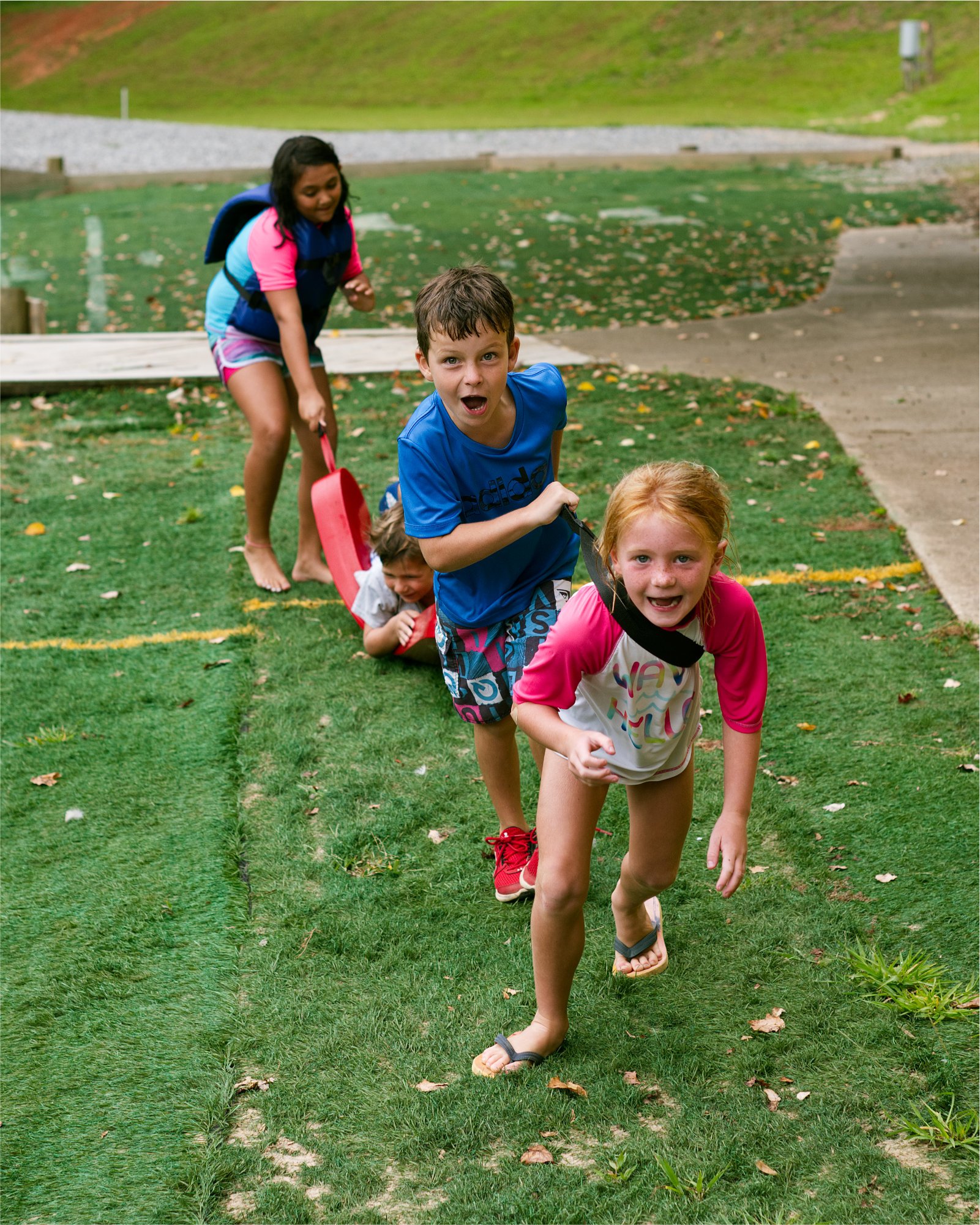 a group of kids play down by the waterfront