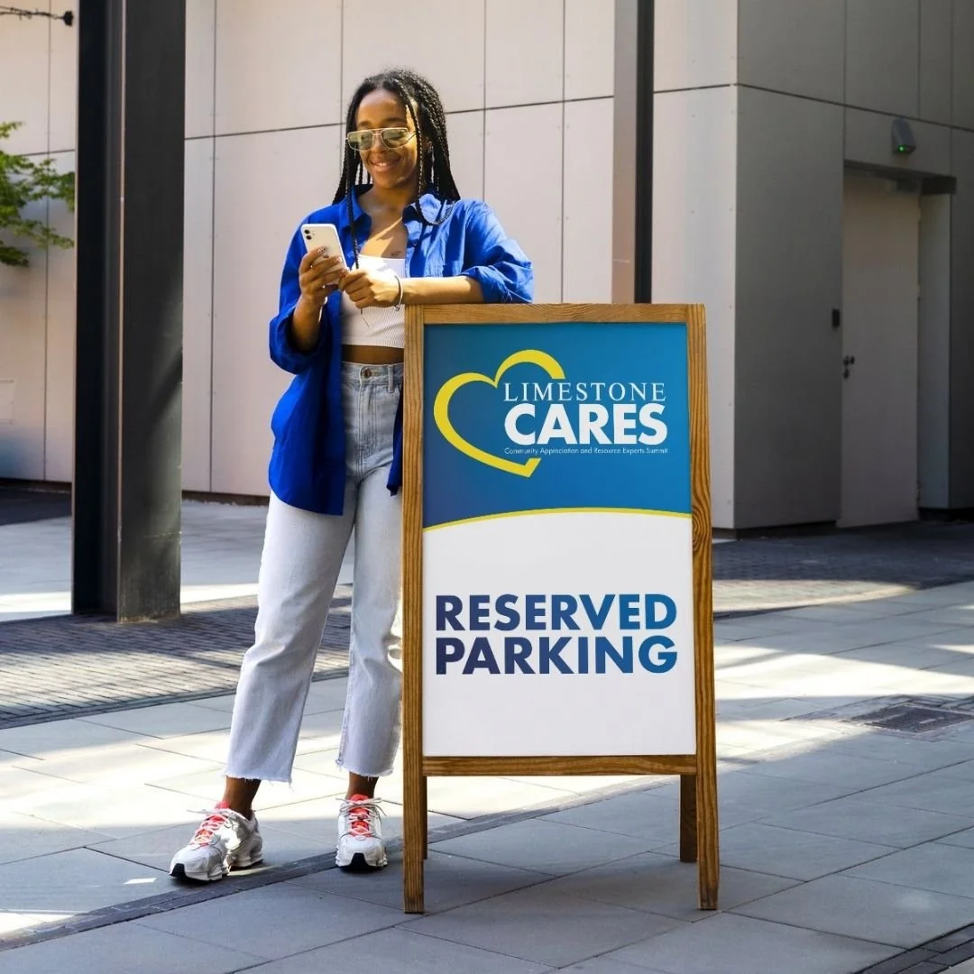 girl standing next to a reserved parking sign