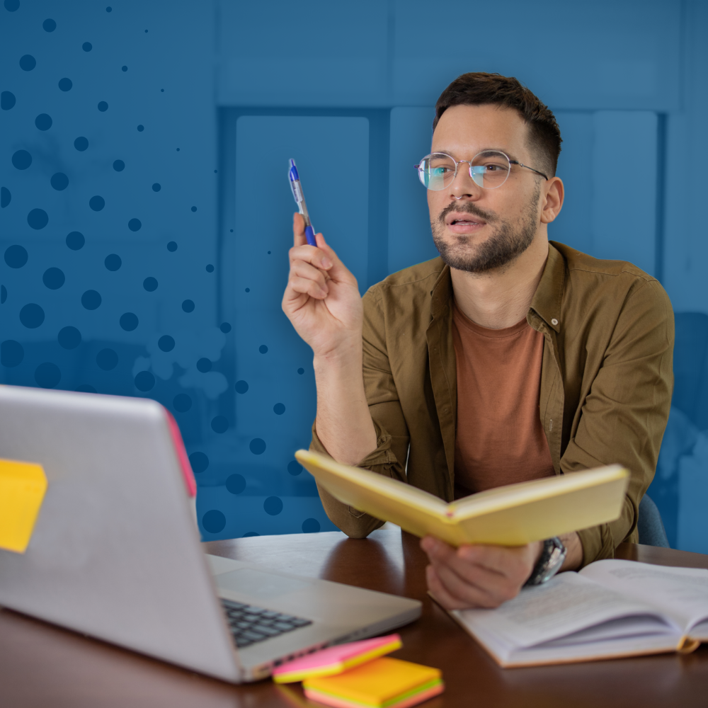Man holding a notebook and pen while explaining an idea