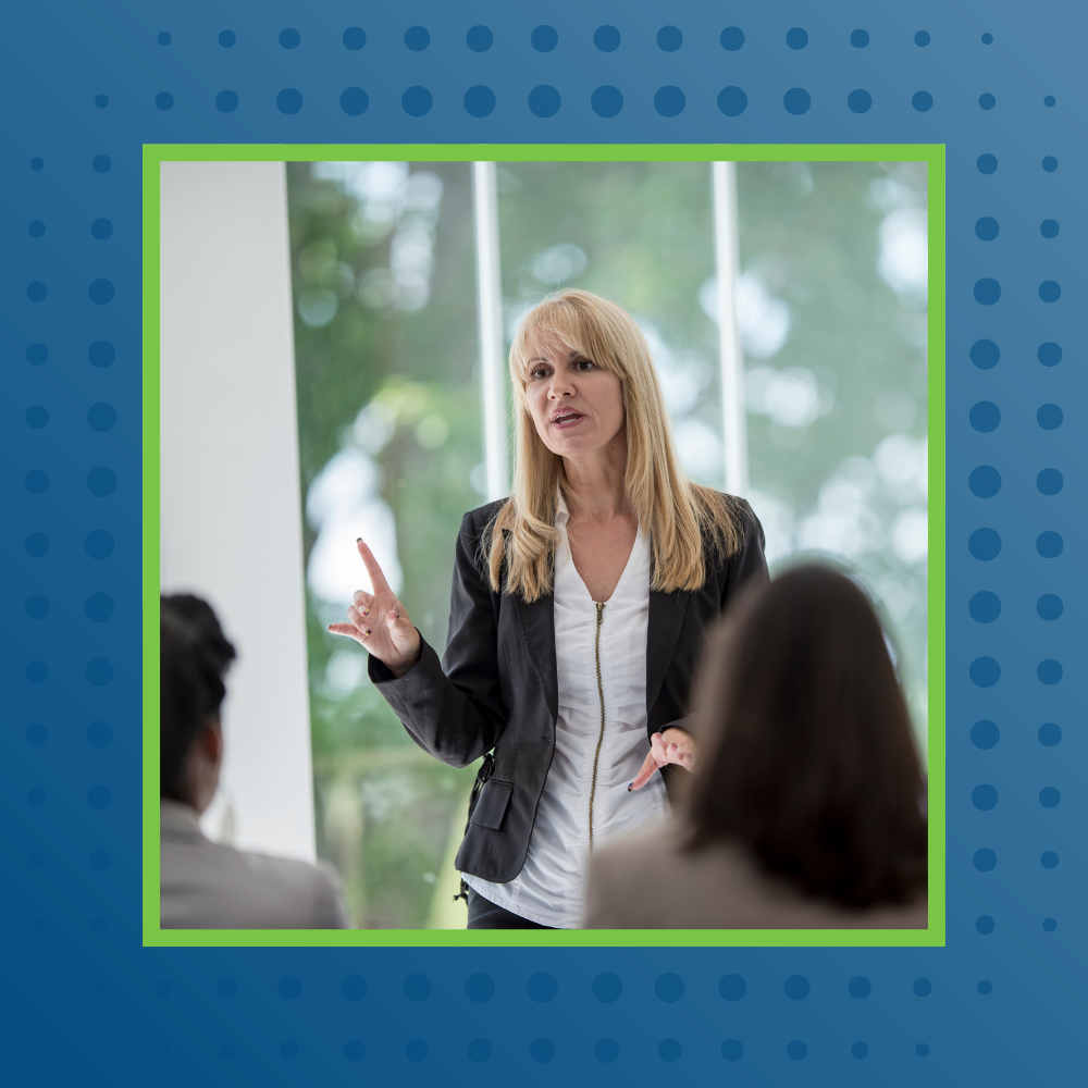 Woman presenting to a room of professionals during a training session