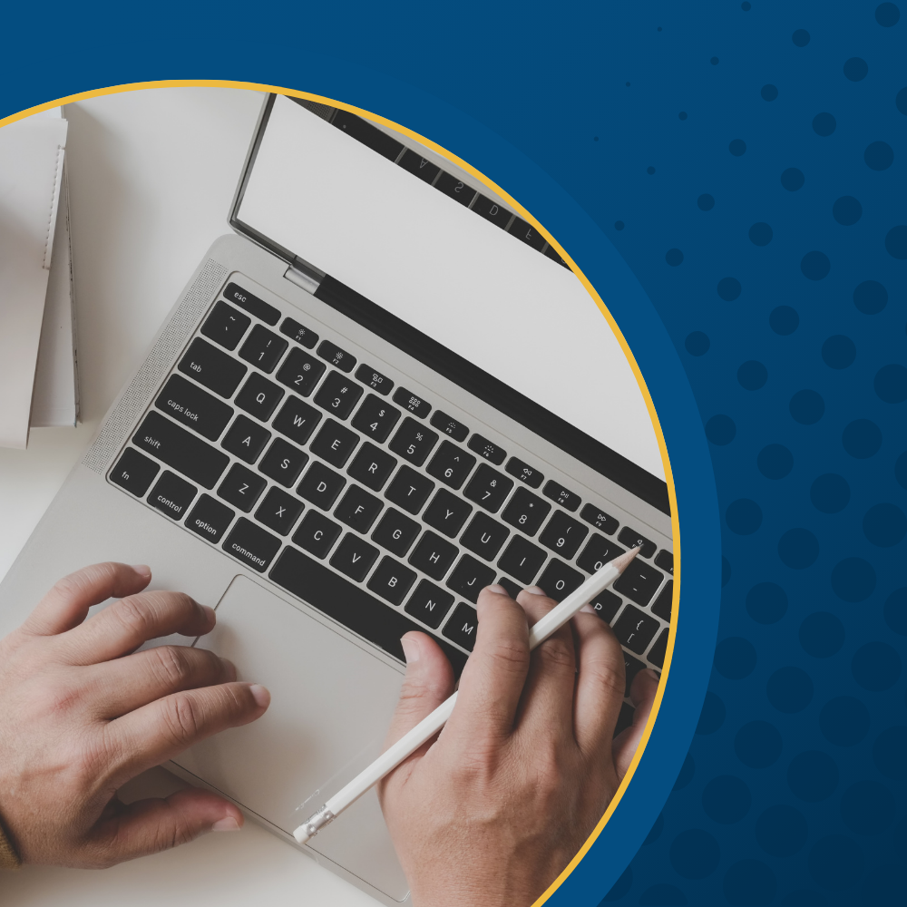 Hands typing on a laptop