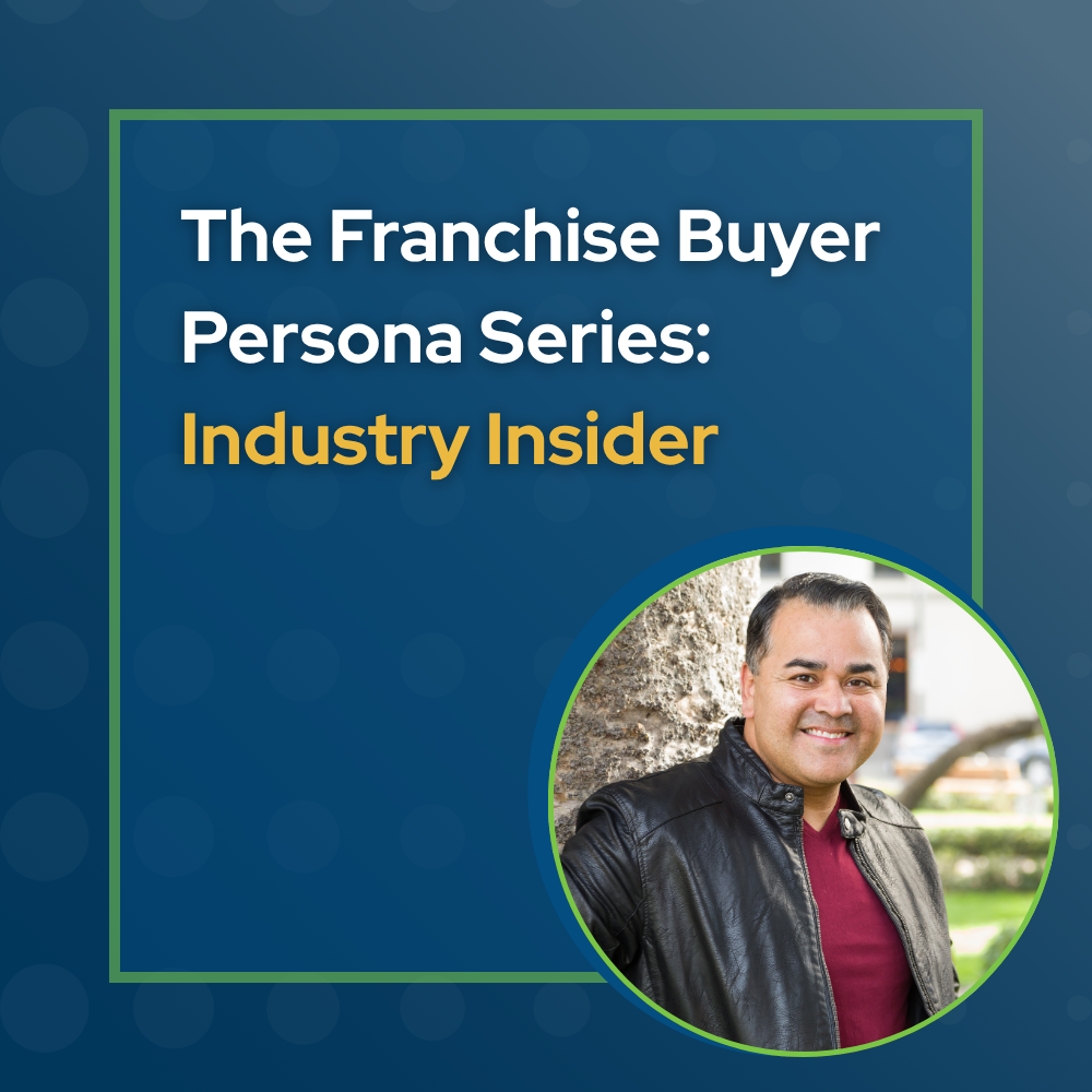 man with dark hair and smiling face wearing a dark red sweater and a black leather jacket over the top. He is standing in front of a tree. he represents the industry insider franchise buyer persona