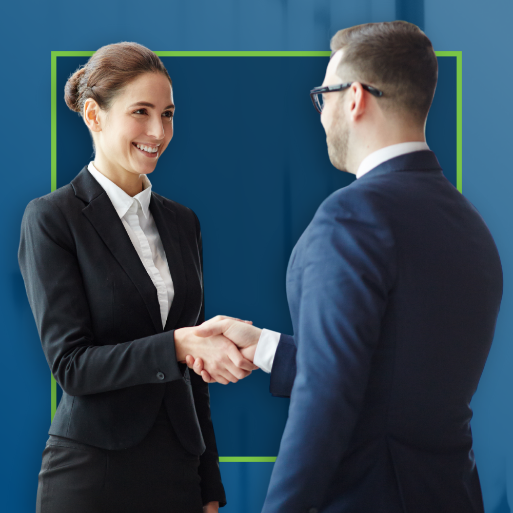 Businesswoman and businessman shaking hands