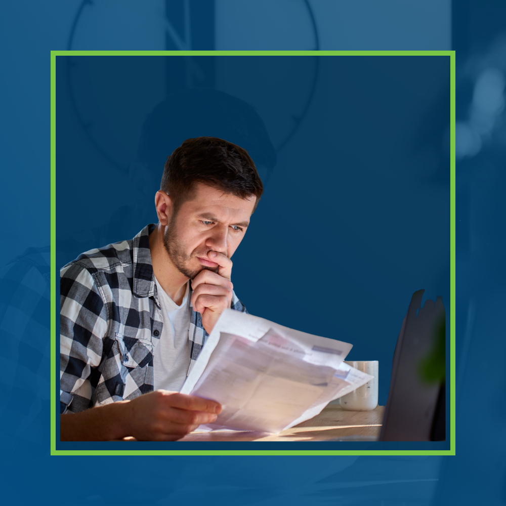 Man studying financial reports at a table