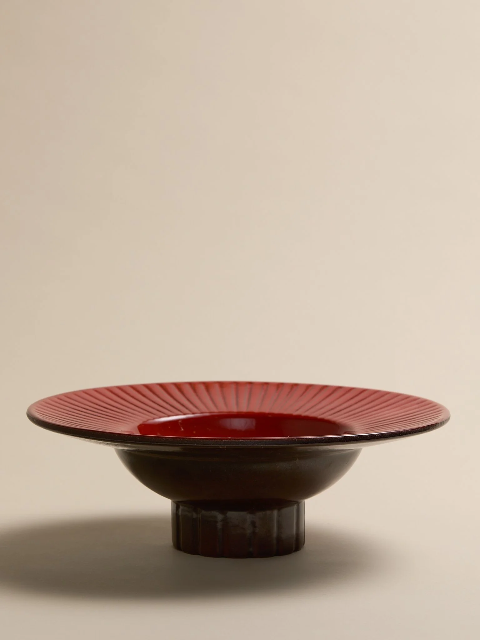 The Vintage Red and Brown Footed Ceramic Bowl with Sunburst Rim