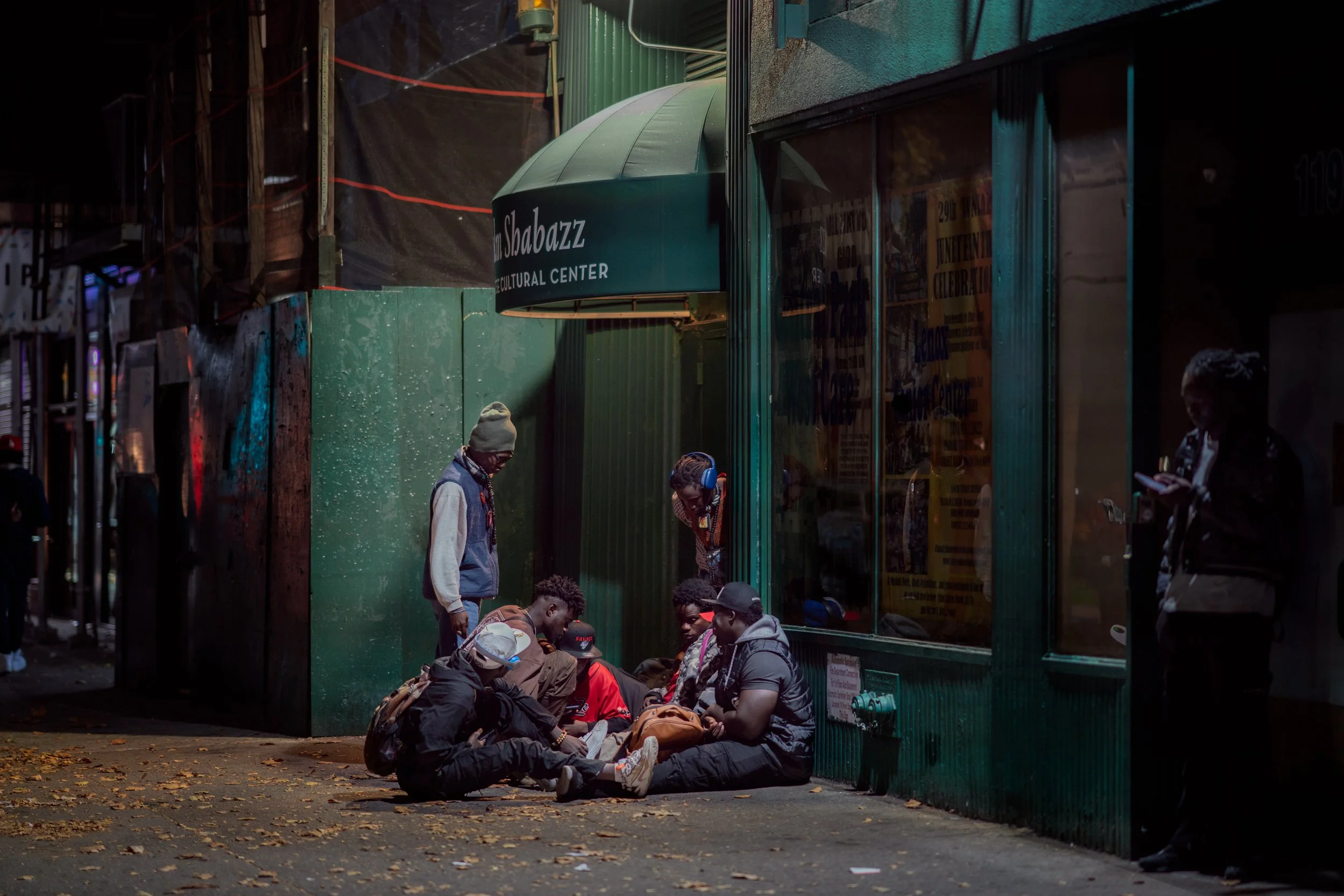 HARLEM, N.Y., October 2024 — Souleye, Noreyni, Mame Cheikh and other Baye Fall men, members of a subgroup of the Mouride Sufi Islamic brotherhood, gather almost every evening on the same corner of West 116th Street in Harlem during fall 2024.