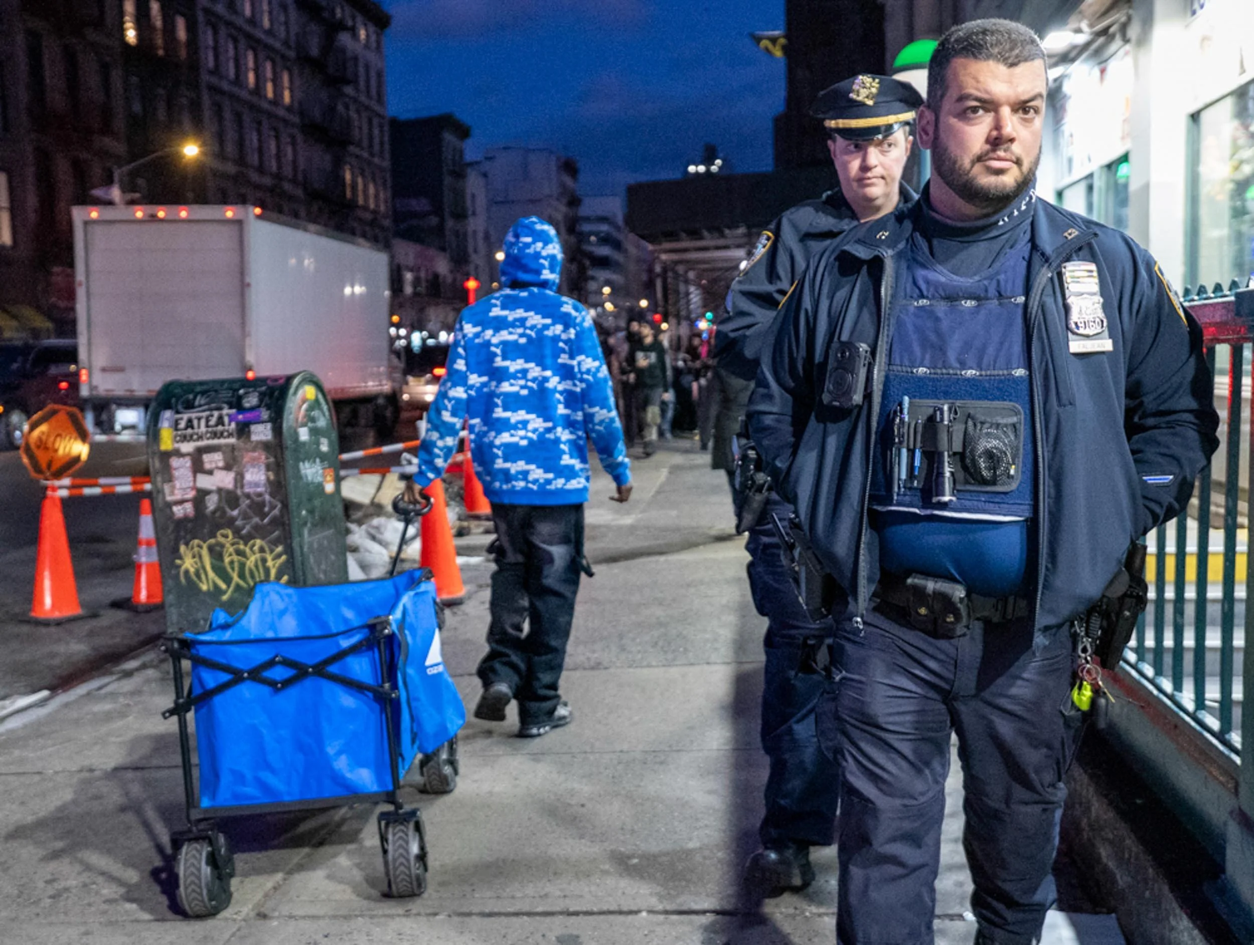 Canal Street, Manhattan — A Senegalese street vendor carries nearly empty rolling racks, usually loaded with bags, on Canal Street in Manhattan on Thursday, November 13, 2025. Many vendors keep their goods packed because of a heavier law enforcement 
