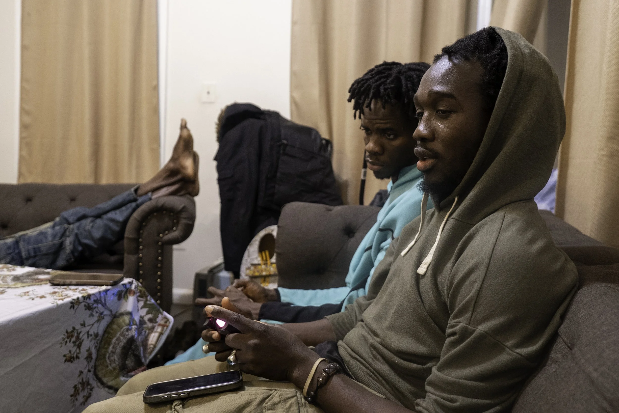 Bronx December 11, 2025 —  Souleye and bayefall from the corner, were playing video games together at Souleye’s new house in the Bronx. Souleye used to live with six other men, but he recently moved to a new place shared with four other Senegaleses a