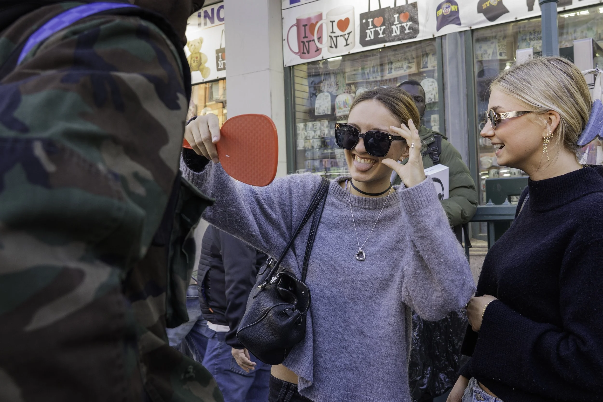 Canal Street, Manhattan — A Senegalese street vendor speaks with passers-by while selling counterfeit sunglasses on Canal Street in Manhattan on Sunday, November 2, 2025. Senegalese vendors say a single pair of sunglasses can bring about $10 in gross