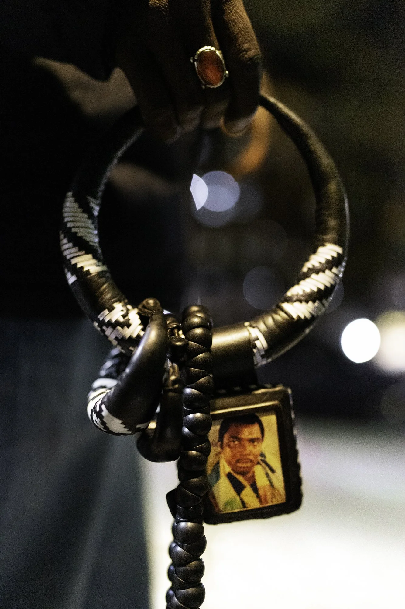 Harlem, October 2024 —A Baye Fall on the corder holds Ndombou Baat, a necklace with an image of a mouride religious leader in Senegal.