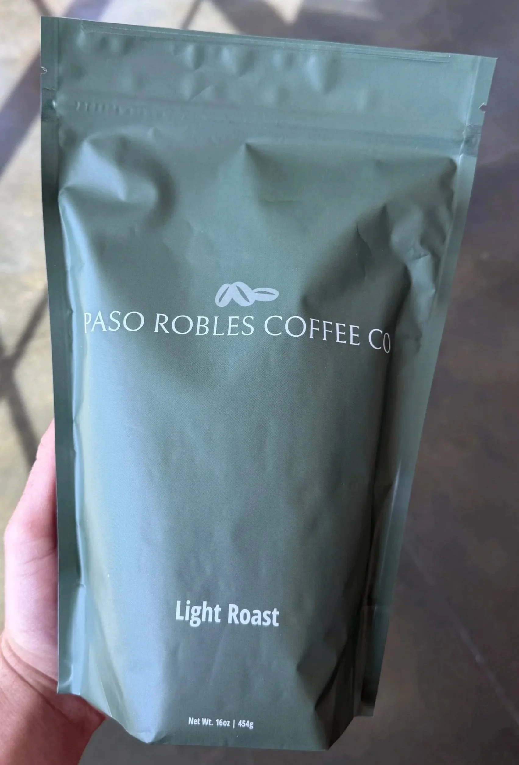 Green coffee package labeled Paso Robles Coffee Co, Light Roast, 16 oz, 454g.