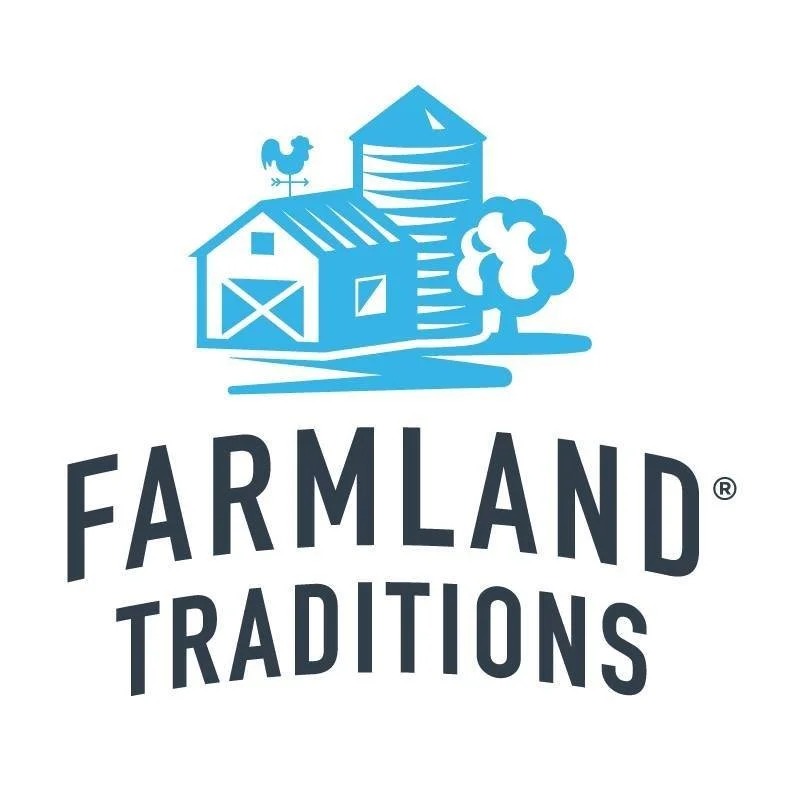Blue illustration of a barn, silo, tree, and weather vane with the text 'Farmland Traditions' below.