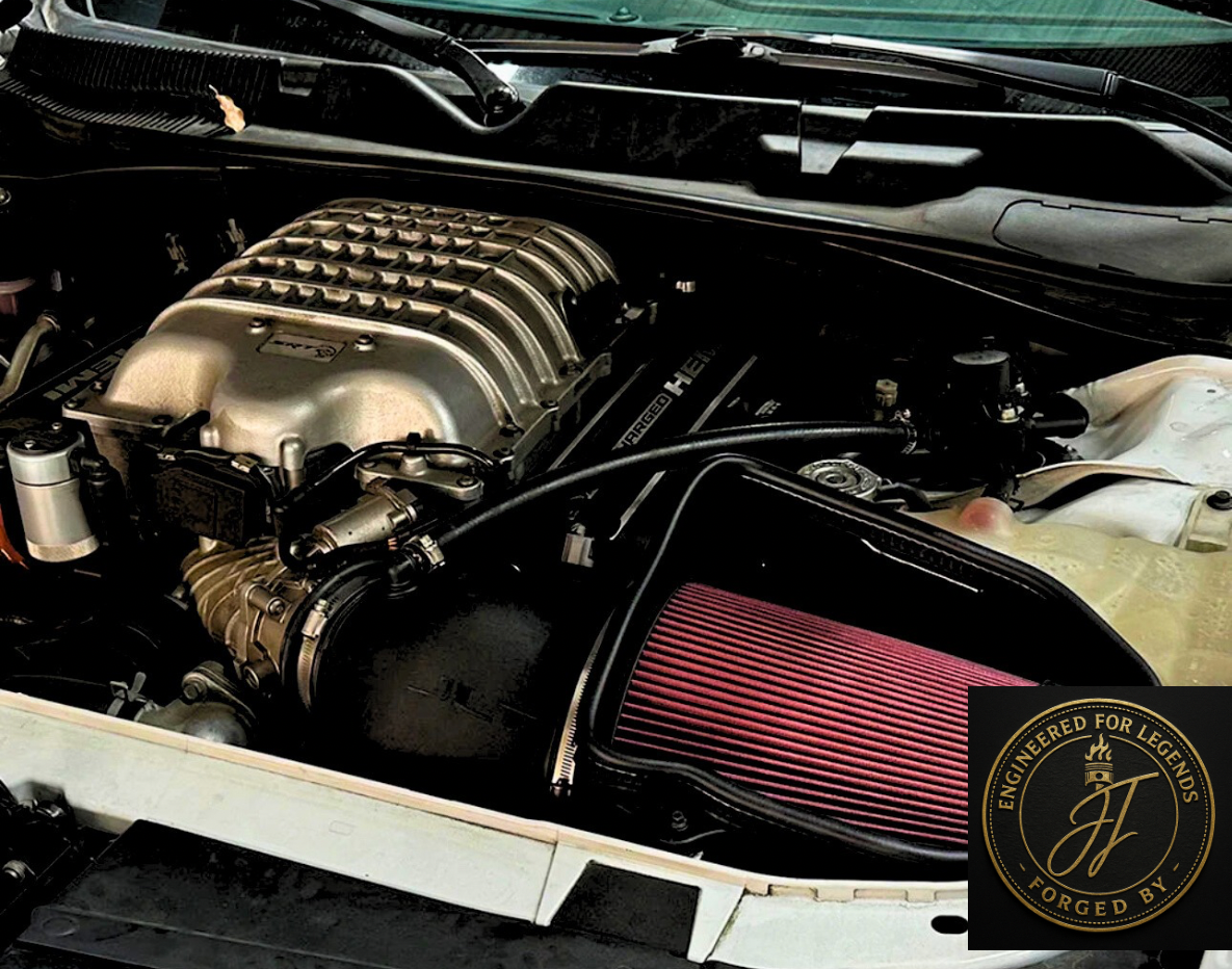 Car engine with a supercharger and air intake filter under a vehicle hood.