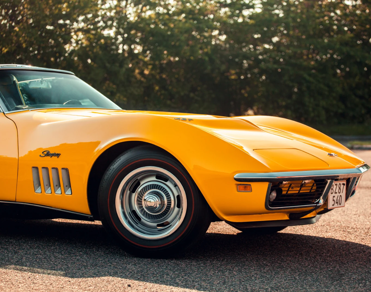 Yellow vintage Corvette Stingray parked on pavement