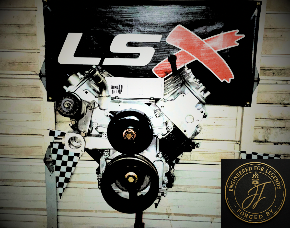 Chevrolet LSX engine displayed vertically on a wall, with a banner labeled "LSX" and "Donald Thump," and a logo "Engineered for Legends, Forged by JF."