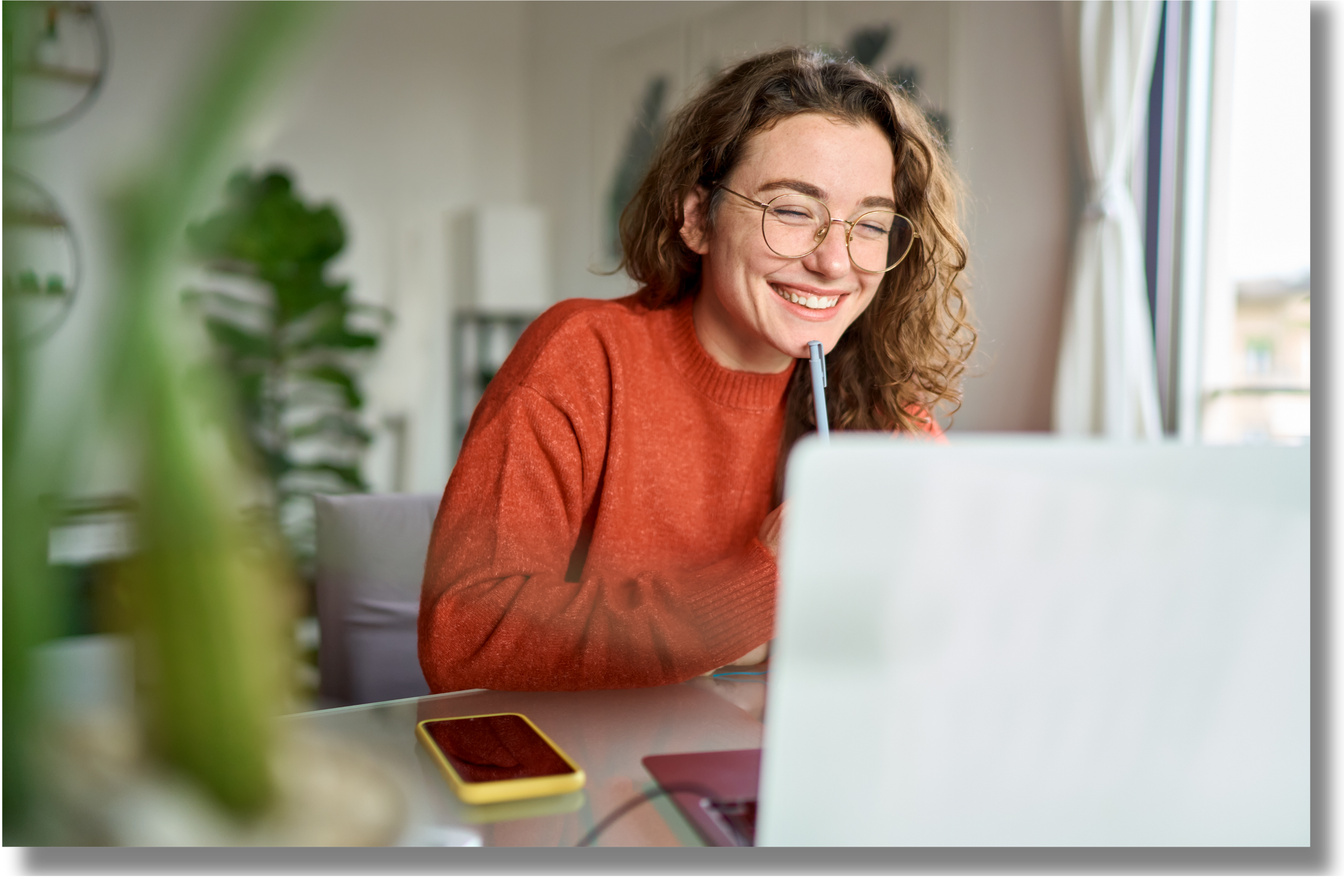 College student smiling during a virtual coaching session on her laptop