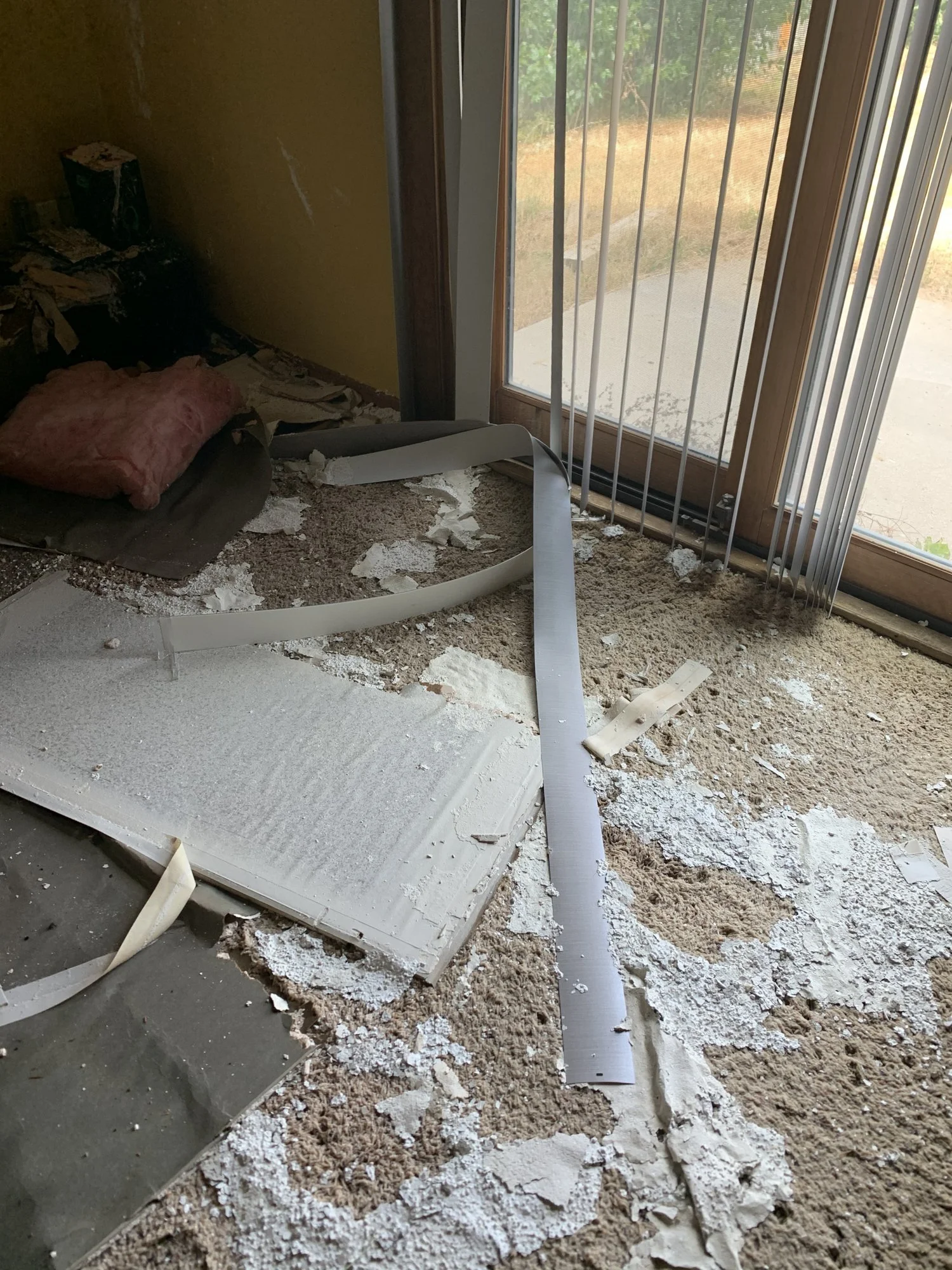 Fallen drywall on wet carpet after a ceiling leak, before water extraction in Sheridan WY