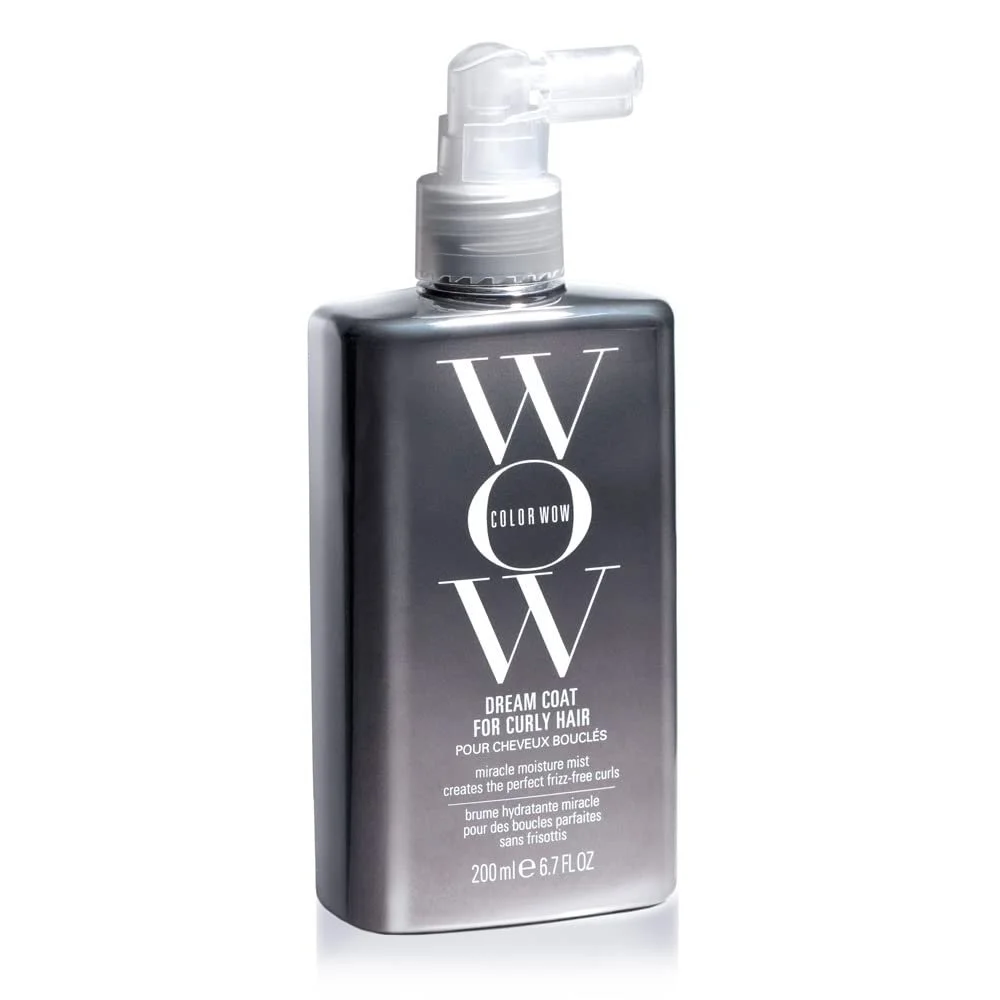 A black and silver spray bottle labeled 'WOW Color Wow Dream Coat for Curly Hair, 200ml, 6.7 Fl Oz, miracle moisture mist for frizz-free curls'