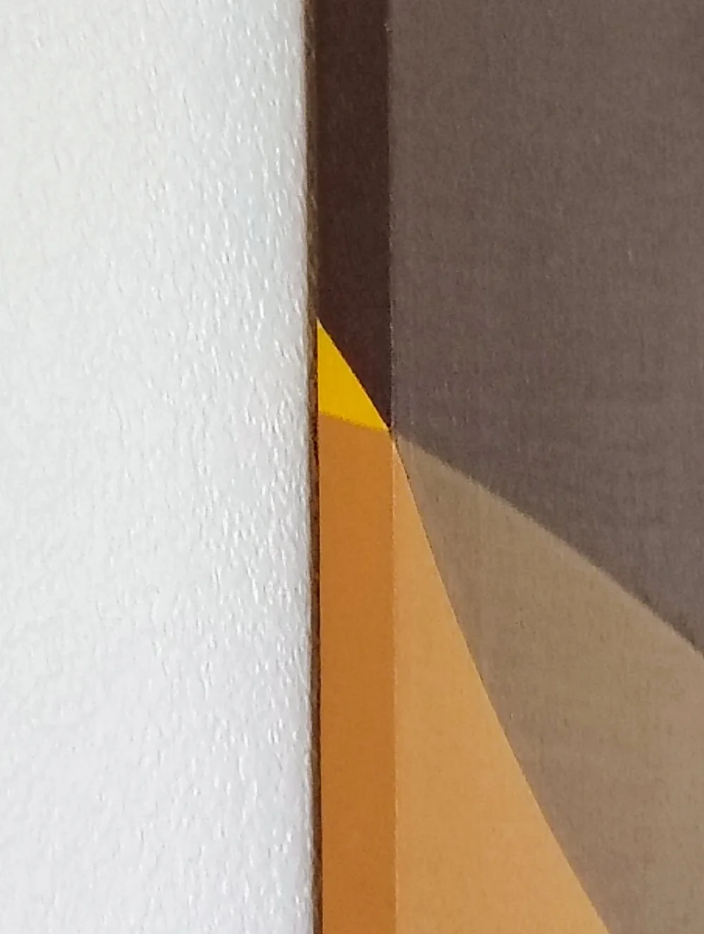 Side detail documenting the painted edge and construction of the Yellow Triangle canvas